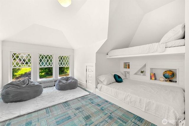 bedroom with baseboards, carpet, and lofted ceiling
