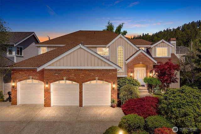 13914 SE 88th Pl, Newcastle, WA 98059 - view of front of home with an attached garage, board and batten siding, driveway, and brick siding