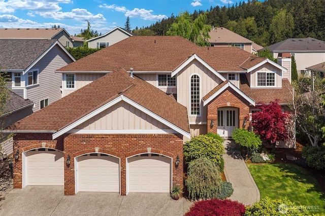 13914 SE 88th Pl, Newcastle, WA 98059 - traditional-style house featuring board and batten siding, brick siding, concrete driveway, an attached garage, and a shingled roof