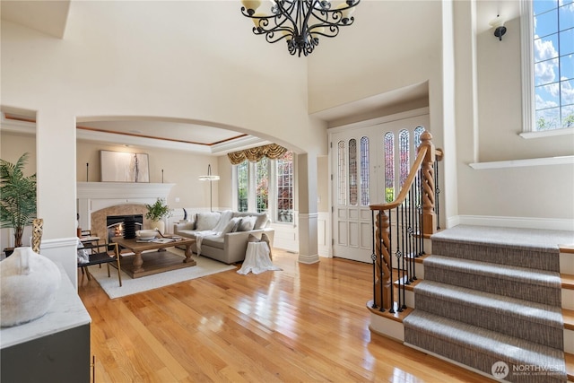13914 SE 88th Pl, Newcastle, WA 98059 - living area with arched walkways, light wood-type flooring, stairs, and a wealth of natural light