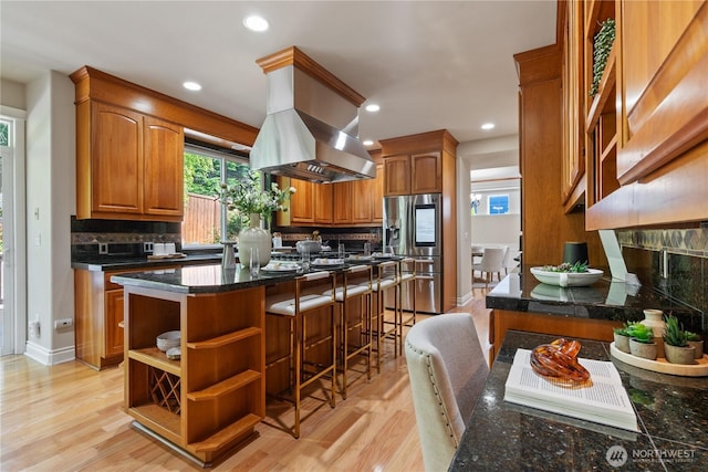 13914 SE 88th Pl, Newcastle, WA 98059 - kitchen featuring stainless steel fridge, plenty of natural light, island range hood, and tasteful backsplash