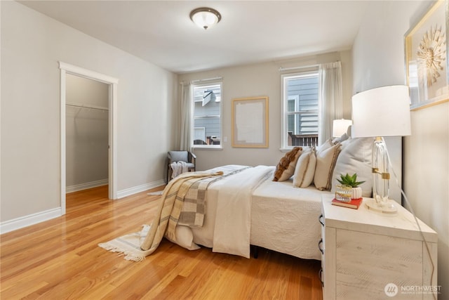 13914 SE 88th Pl, Newcastle, WA 98059 - bedroom with light wood-style floors, baseboards, a closet, and a spacious closet