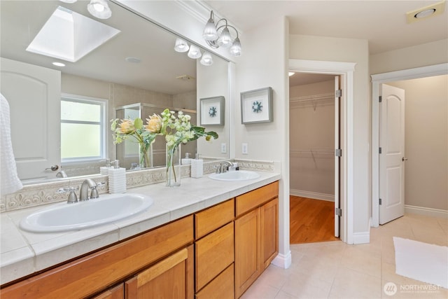 13914 SE 88th Pl, Newcastle, WA 98059 - bathroom with double vanity, a skylight, a shower stall, and a sink