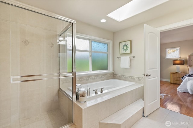13914 SE 88th Pl, Newcastle, WA 98059 - ensuite bathroom with a stall shower, ensuite bath, a healthy amount of sunlight, and a skylight