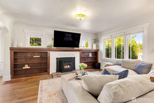 1002 S Adams St, Tacoma, WA 98405 - living room featuring wood finished floors, arched walkways, and baseboards