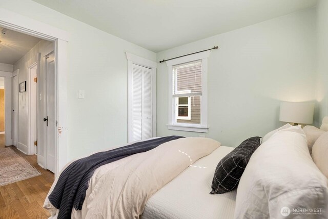 1002 S Adams St, Tacoma, WA 98405 - bedroom featuring wood finished floors, a closet, and baseboards
