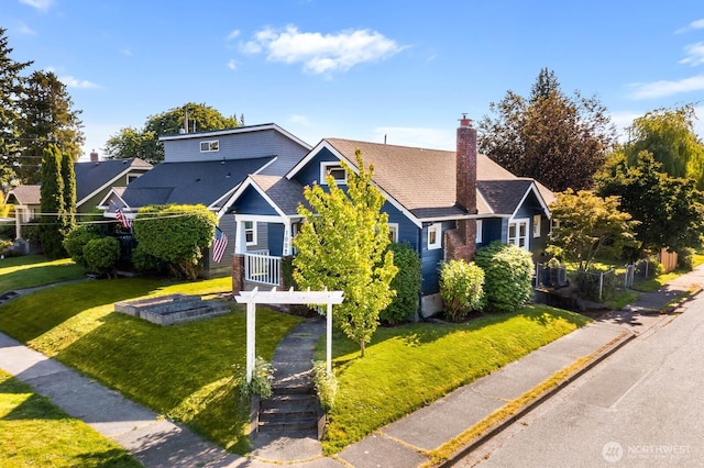 1002 S Adams St, Tacoma, WA 98405 - view of front of home featuring a chimney and a front yard
