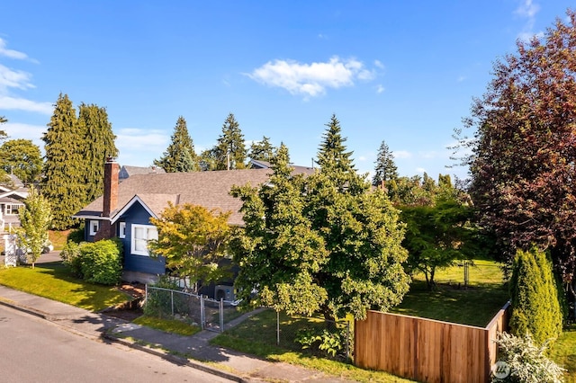 1002 S Adams St, Tacoma, WA 98405 - view of side of home featuring a chimney, roof with shingles, and a gate