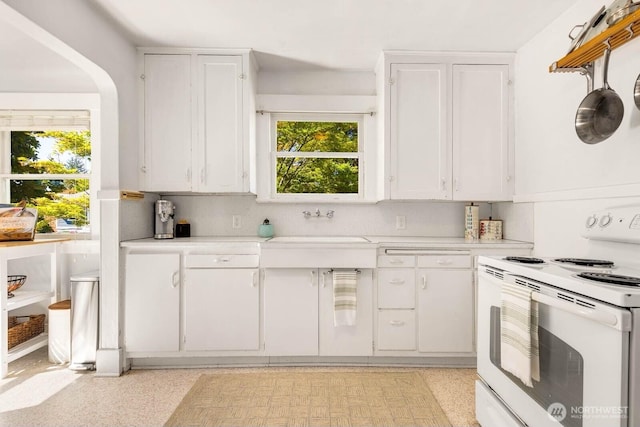 1002 S Adams St, Tacoma, WA 98405 - kitchen with white electric range oven, light countertops, a sink, and white cabinets