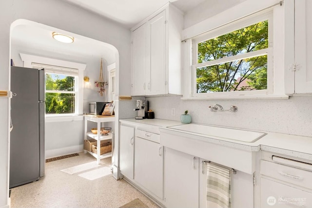 1002 S Adams St, Tacoma, WA 98405 - kitchen featuring freestanding refrigerator, a sink, light countertops, and white cabinetry