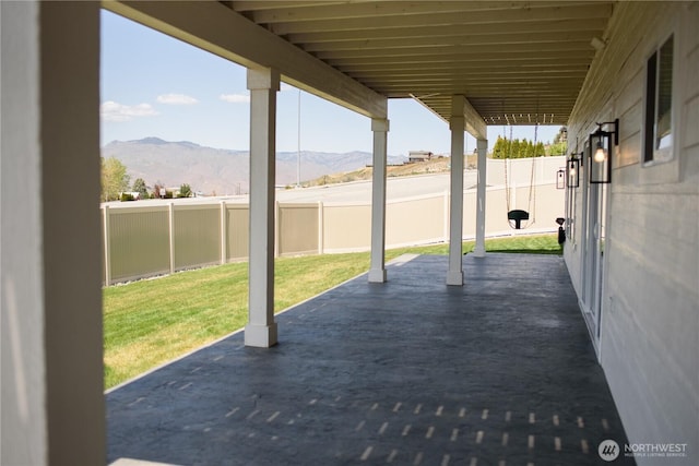 view of patio / terrace with a fenced backyard and a mountain view