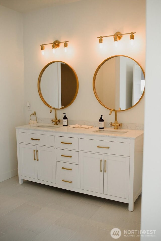bathroom featuring double vanity, a sink, and tile patterned flooring