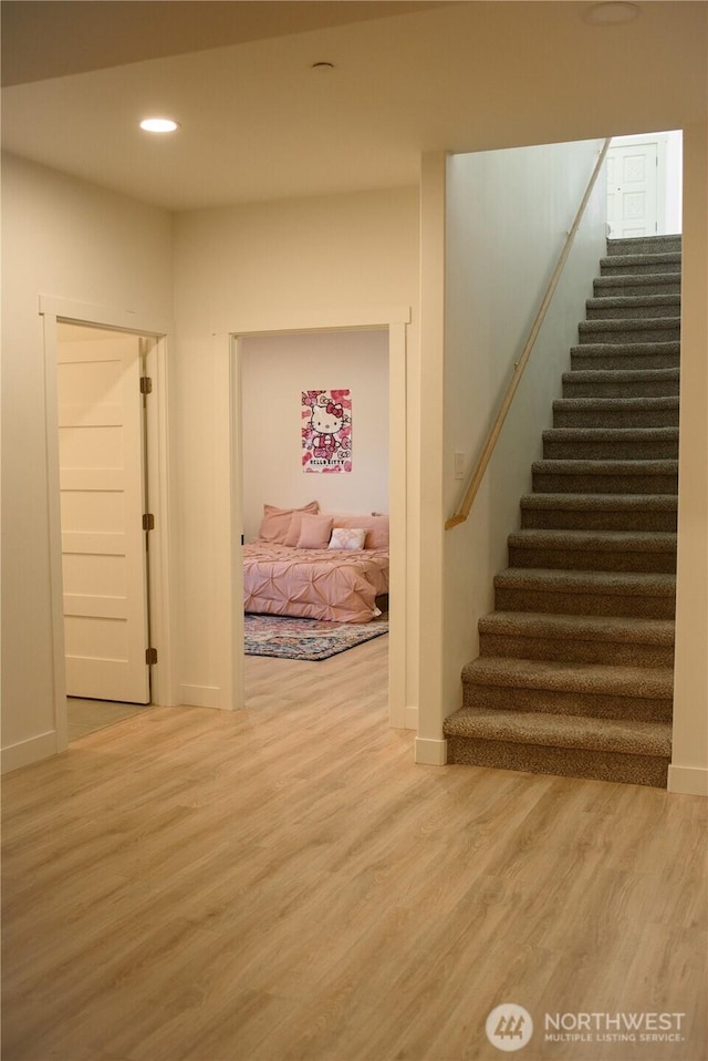 interior space with recessed lighting, baseboards, and wood finished floors