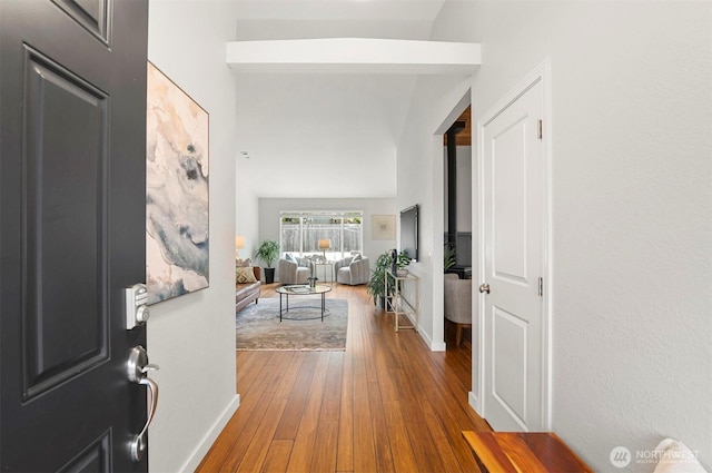 entryway with baseboards and hardwood / wood-style floors