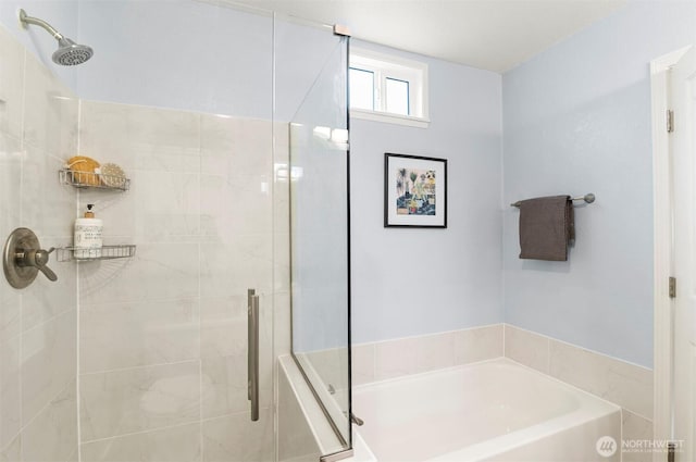 bathroom with a shower stall and a garden tub
