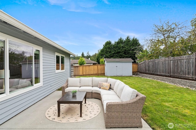 view of patio featuring an outdoor hangout area, a storage unit, an outbuilding, and a fenced backyard
