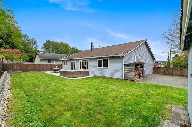 back of house featuring a patio, a fenced backyard, and a yard