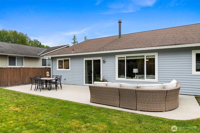 back of house featuring fence, a patio, roof with shingles, an outdoor living space, and a lawn