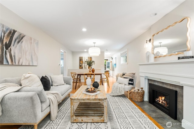 living area with recessed lighting and a tile fireplace