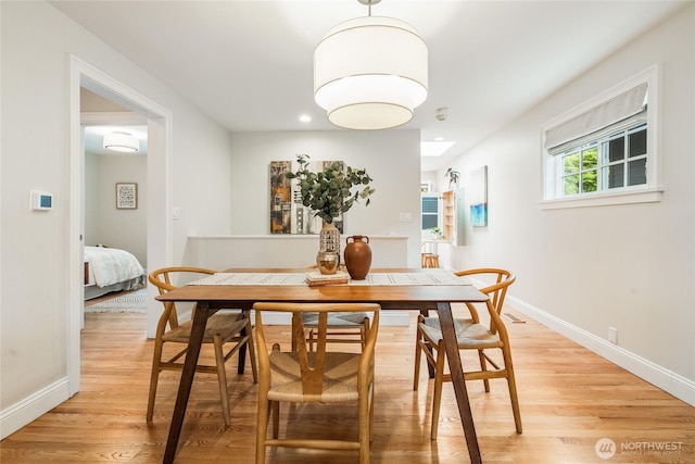 dining area with light wood-type flooring, recessed lighting, and baseboards