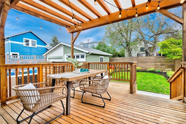 wooden deck featuring outdoor dining area, a lawn, an outdoor structure, a fenced backyard, and a pergola