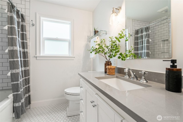 bathroom featuring vanity, baseboards, and toilet