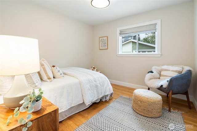 bedroom featuring baseboards and light wood-type flooring