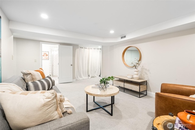 living area featuring recessed lighting, baseboards, light colored carpet, and visible vents