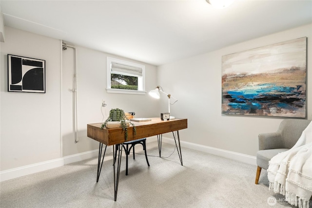 office space featuring baseboards and light carpet