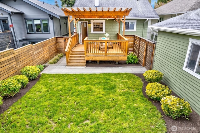 back of property featuring a deck, a fenced backyard, a yard, a pergola, and a shingled roof