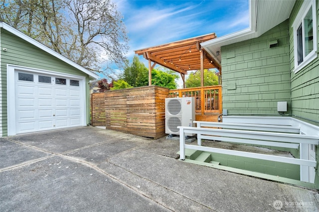exterior space featuring a garage, fence, a pergola, and driveway