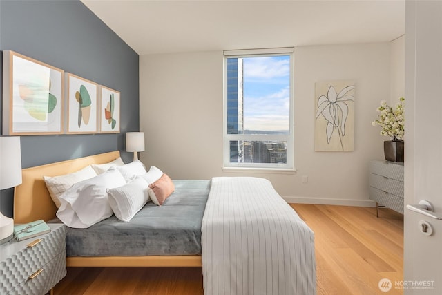 bedroom featuring baseboards and wood finished floors