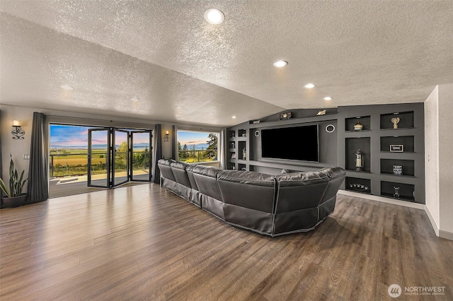 living area with built in features, dark wood finished floors, a textured ceiling, and lofted ceiling