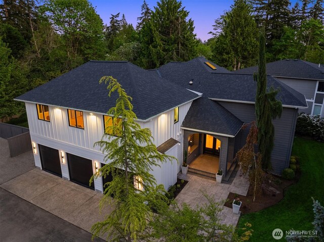 9732 Slater Ave NE, Kirkland, WA 98033 - view of front of home with board and batten siding, driveway, roof with shingles, and a garage