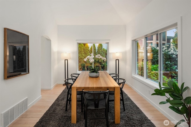 9732 Slater Ave NE, Kirkland, WA 98033 - dining space with light wood-style floors, baseboards, arched walkways, and visible vents