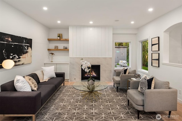 9732 Slater Ave NE, Kirkland, WA 98033 - living room with a tiled fireplace, arched walkways, recessed lighting, and wood finished floors