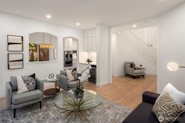 9732 Slater Ave NE, Kirkland, WA 98033 - living area with stairs, wine cooler, light wood-style floors, baseboards, and recessed lighting