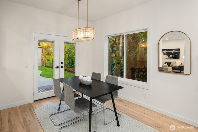 9732 Slater Ave NE, Kirkland, WA 98033 - dining space featuring baseboards, an inviting chandelier, french doors, and wood finished floors