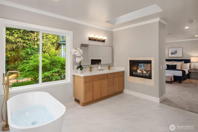 9732 Slater Ave NE, Kirkland, WA 98033 - ensuite bathroom featuring ensuite bath, double vanity, a multi sided fireplace, ornamental molding, and a soaking tub