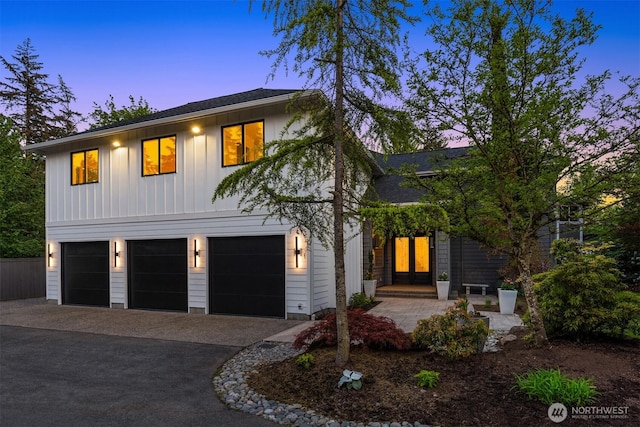 9732 Slater Ave NE, Kirkland, WA 98033 - view of front of home with an attached garage, board and batten siding, and driveway
