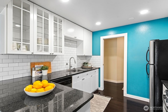 kitchen with freestanding refrigerator, baseboards, dark wood-style floors, white cabinetry, and a sink