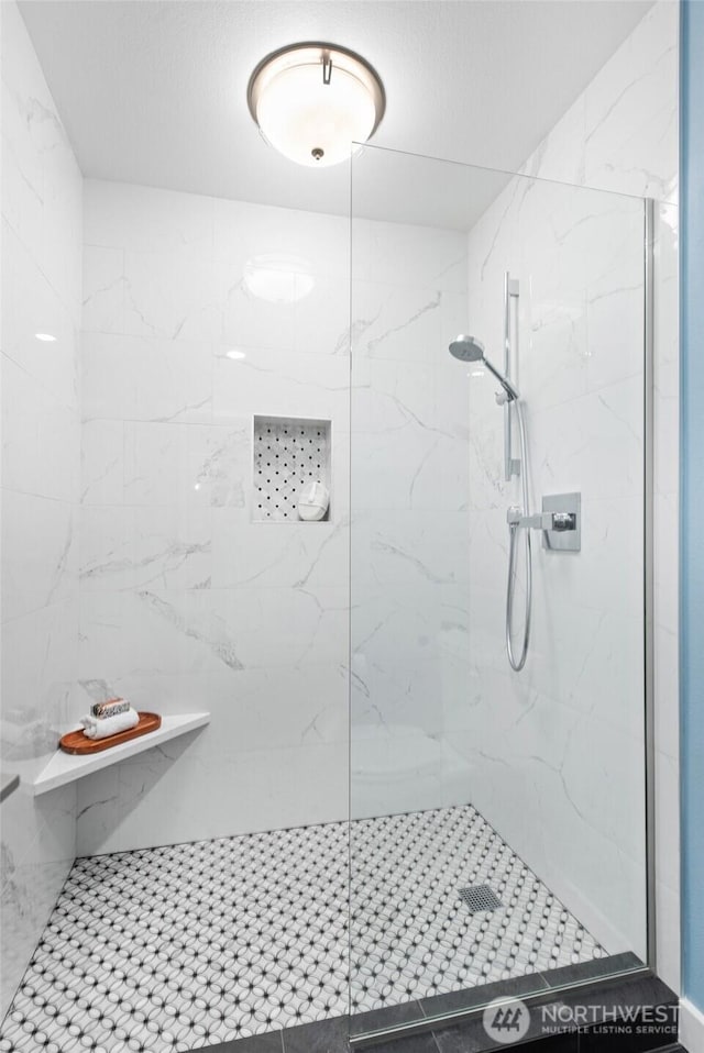 bathroom with a marble finish shower