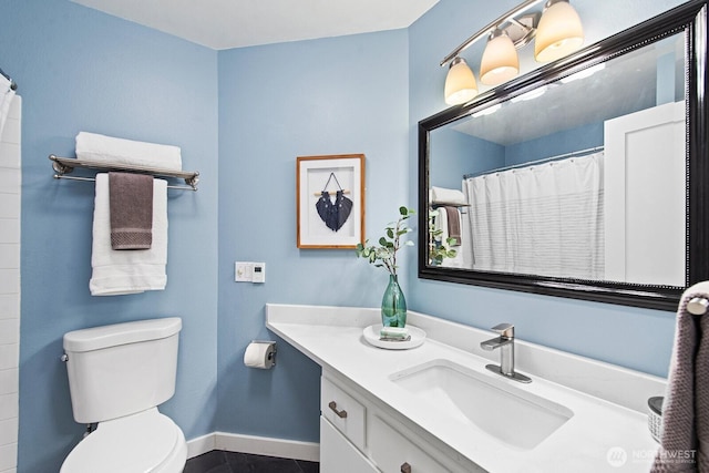bathroom featuring vanity, toilet, tile patterned floors, a shower with shower curtain, and baseboards