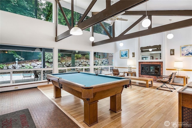 13743 15th Ave NE Unit D6, Seattle, WA 98125 - recreation room with a high ceiling, billiards, healthy amount of natural light, a brick fireplace, and beam ceiling