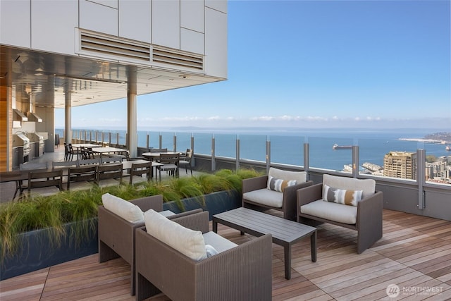 wooden deck featuring an outdoor hangout area and a water view