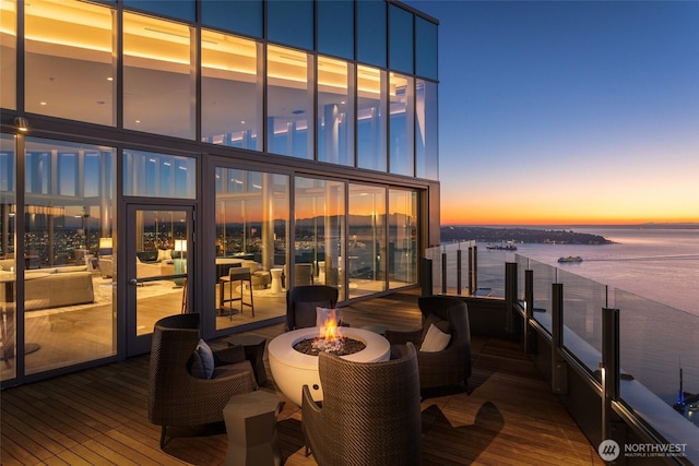 deck featuring a water view and a fire pit