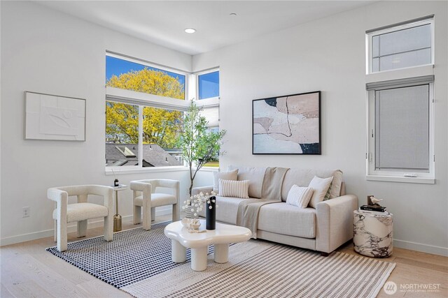 living area featuring baseboards, recessed lighting, and wood finished floors