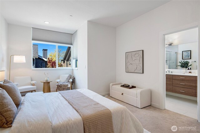 bedroom featuring baseboards, ensuite bathroom, light carpet, and recessed lighting