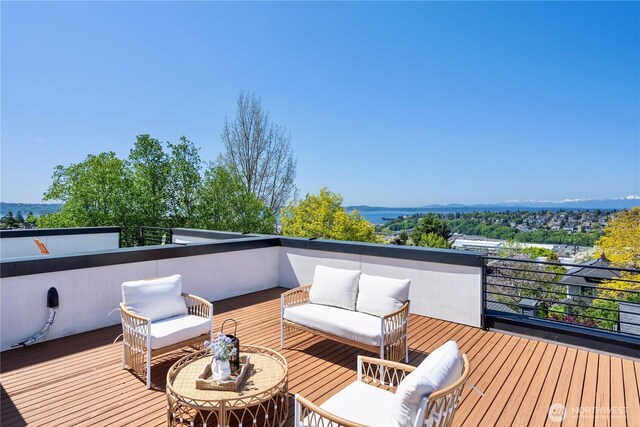 wooden deck featuring a mountain view and an outdoor living space