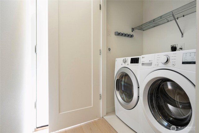 laundry room with separate washer and dryer and laundry area